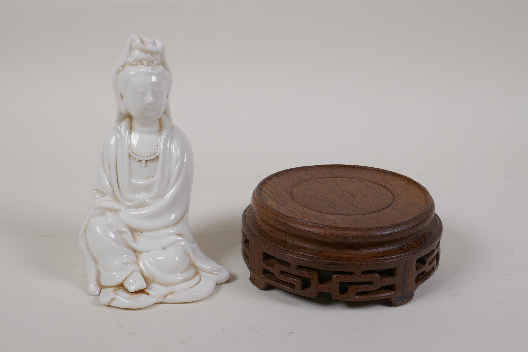 A Chinese blanc de chine porcelain Quan Yin, on a turned and pierced hardwood stand, impressed marks - Image 4 of 4