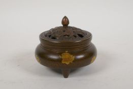 A Chinese gilt splash bronze censer and cover on tripod supports, 3½" diameter