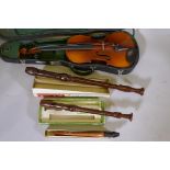 A viola in case, and three recorders