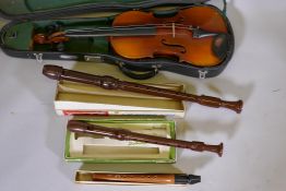 A viola in case, and three recorders