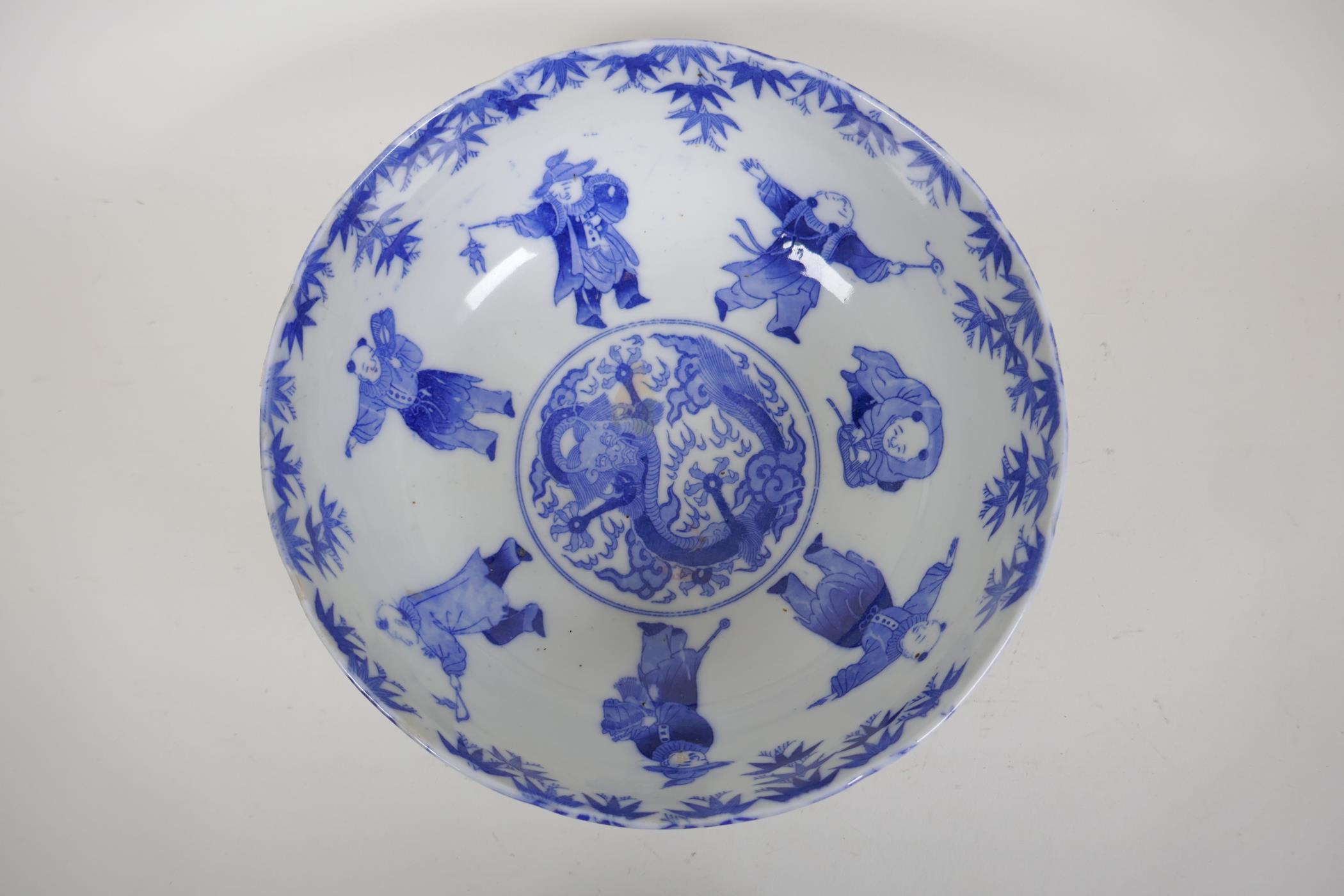 A Chinese Republic blue and white porcelain punch bowl decorated with boys at various pursuits,