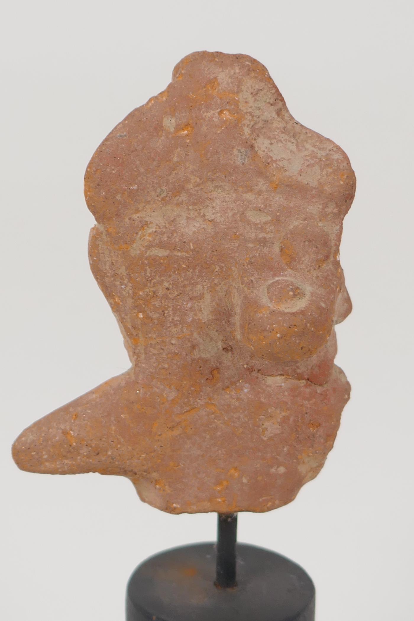 An Eastern terracotta head, 3" long, on turned stand - Image 2 of 2