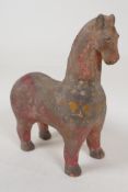 A Middle Eastern terracotta figurine of a horse with painted decoration, 8½" high
