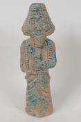 A Persian terracotta figurine of a dignitary, traces of paint, 9" high