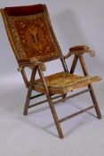 A Victorian folding campaign armchair, with original upholstery, bears label Automatic Patent