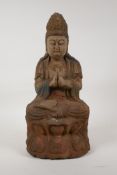 A Chinese carved and painted wood figure of Quan Yin seated on a lotus throne, 14½" high