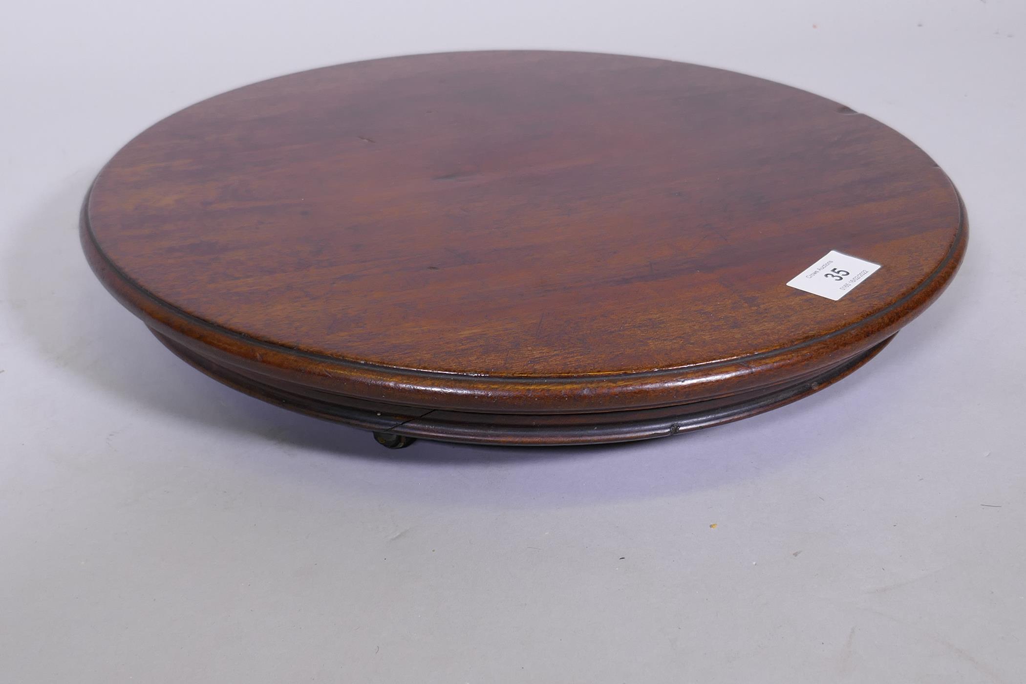 A mahogany revolving table stand, fitted with three brass and leather castors, 15" diameter - Image 2 of 4