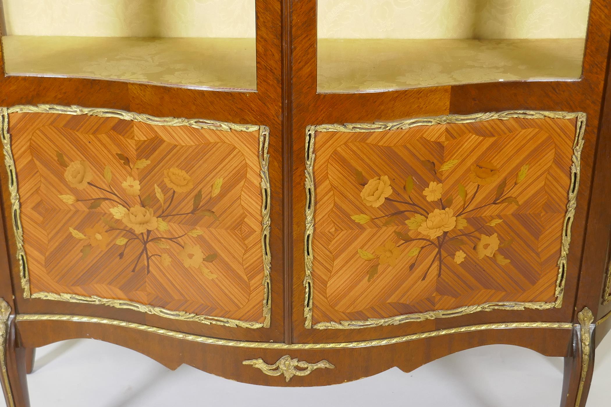 A French marquetry inlaid mahogany serpentine front vitrine with brass mounts, the interior with - Image 2 of 6