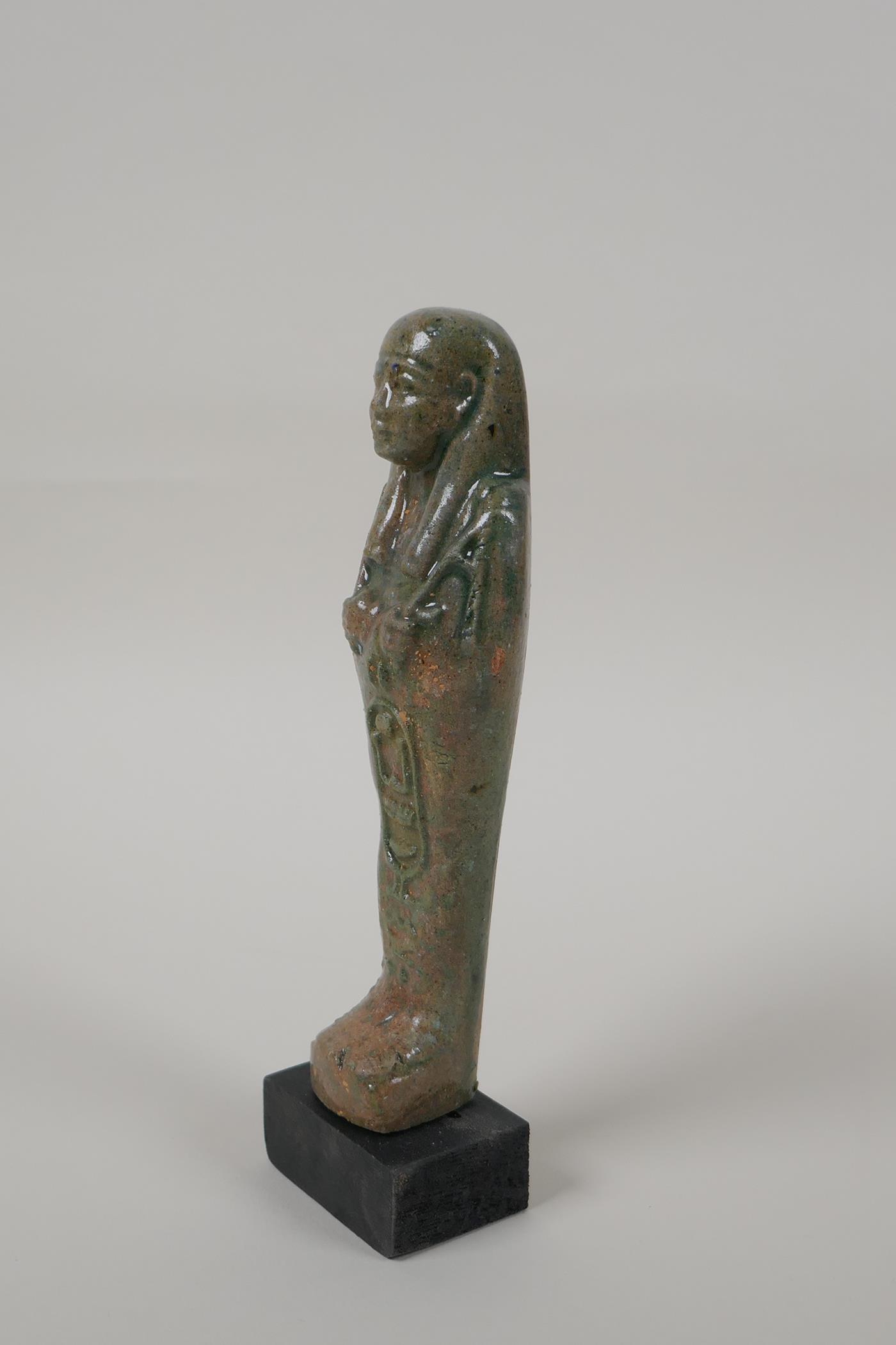 An Egyptian turquoise glazed faience shabti, mounted on a display base, 7" high - Image 4 of 4