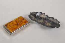 A Chinese faux horn lotus flower shaped trinket dish, and an amber mounted metal cigarette case,