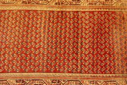 A terracotta ground Persian runner with a sarouk mir design, 41" x 127", minor repair