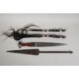 An African dagger with leather handle, two African fly whips with metal banded handles, and a