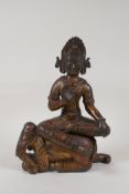A Sino Tibetan gilt bronze figure of Buddha riding an elephant, 9½" high