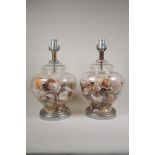 A pair of glass table lamps filled with shells, with chromed metal mounts, one AF, 15½"