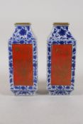 A pair of blue and white porcelain vases with red and gilt decorative panels depicting birds and
