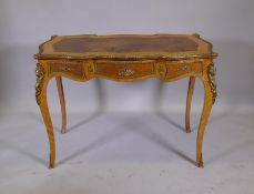 A Louis XV style inlaid tulipwood and brass mounted writing table, with inset leather top and