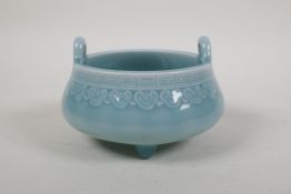 A duck egg blue glazed porcelain two handled censer on tripod supports, underglaze Chinese