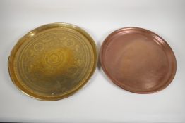 An antique Persian brass tray engraved with stylised lions, 17" diameter, and an early copper
