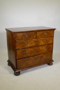 An C18th Georgian walnut chest of two over three drawers, later mahogany top and brass ring handles,