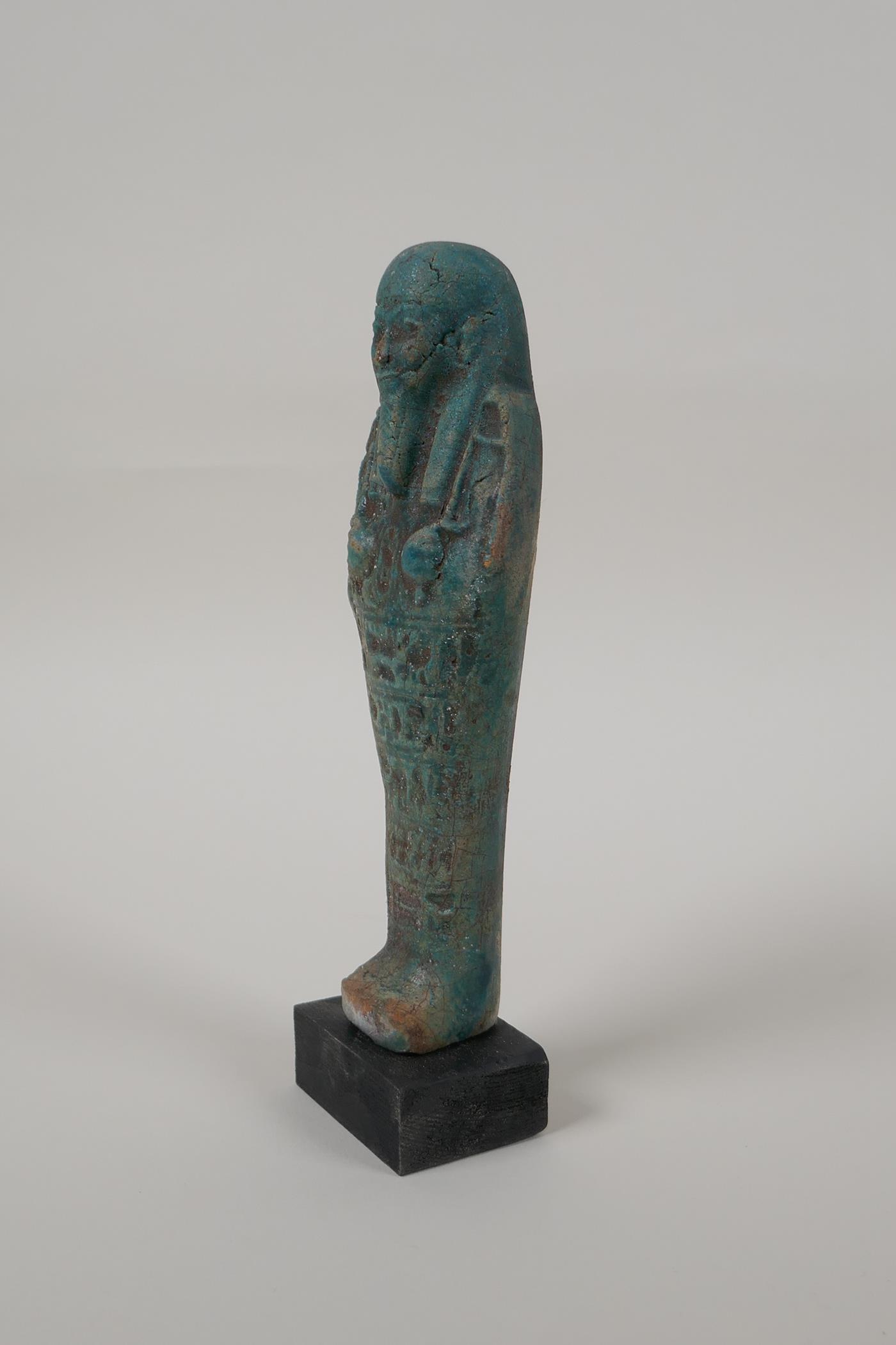 An Egyptian turquoise glazed faience shabti, mounted on a display base, 7" high - Image 5 of 5