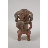 A pre-Columbian painted terracotta figure, 7" high