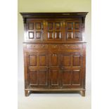 An antique C18th Welsh oak duaddern, the upper section with Greek key carved cornice over the