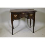 A Georgian oak lowboy, with three drawers, pierced fret brass handles, the kneehole with carved