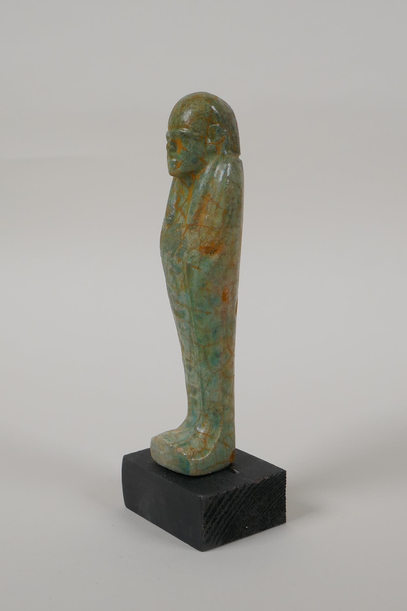 An Egyptian turquoise glazed faience shabti, mounted on a display base, 6" high - Image 6 of 6