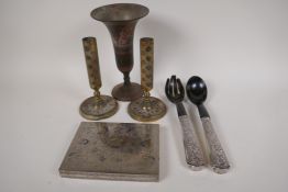 A Benares brass trumpet vase and a pair of candlesticks, an engraved and enamelled table cigarette