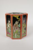 A polychrome porcelain brush pot, decorated with famille noir panels depicting the eight
