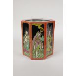 A polychrome porcelain brush pot, decorated with famille noir panels depicting the eight