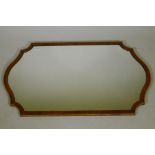 A walnut and parcel gilt shaped wall mirror, 50" x 30"