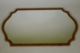 A walnut and parcel gilt shaped wall mirror, 50" x 30"