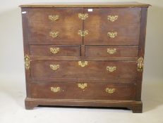 An early C18th oak chest, two cupboards over two + two drawers with original plate handles, raised