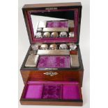 A C19th rosewood vanity box with shell inlaid cartouche and key plate, with fitted interior and
