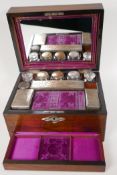 A C19th rosewood vanity box with shell inlaid cartouche and key plate, with fitted interior and