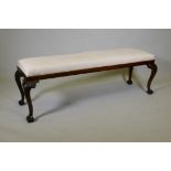 A Chippendale style mahogany window seat, raised on carved cabriole supports with claw and ball