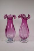 A pair of amethyst glass vases with frilled rims, 14½" high
