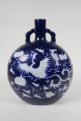A Chinese blue and white porcelain two handled moon flask with incised phoenix decoration, 11" high