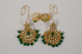 A pair of Indian gilt metal drop earrings with green semi precious stones and enamelled details, and