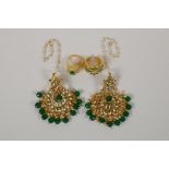 A pair of Indian gilt metal drop earrings with green semi precious stones and enamelled details, and