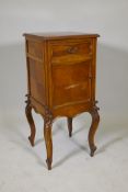 A C19th French walnut bedside cabinet, with single drawer over a cupboard, raised on carved cabriole