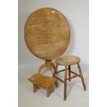 A circular pedestal breakfast table, 27" high, 29" diameter, and two rustic stools