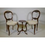 A pair of Victorian mahogany balloon back chairs and a mahogany wine table on tripod supports