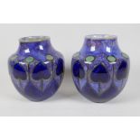 A pair of Royal Doulton Art Nouveau pattern stoneware vases, marked for Ethel Beard, 6½" high, AF