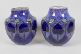 A pair of Royal Doulton Art Nouveau pattern stoneware vases, marked for Ethel Beard, 6½" high, AF