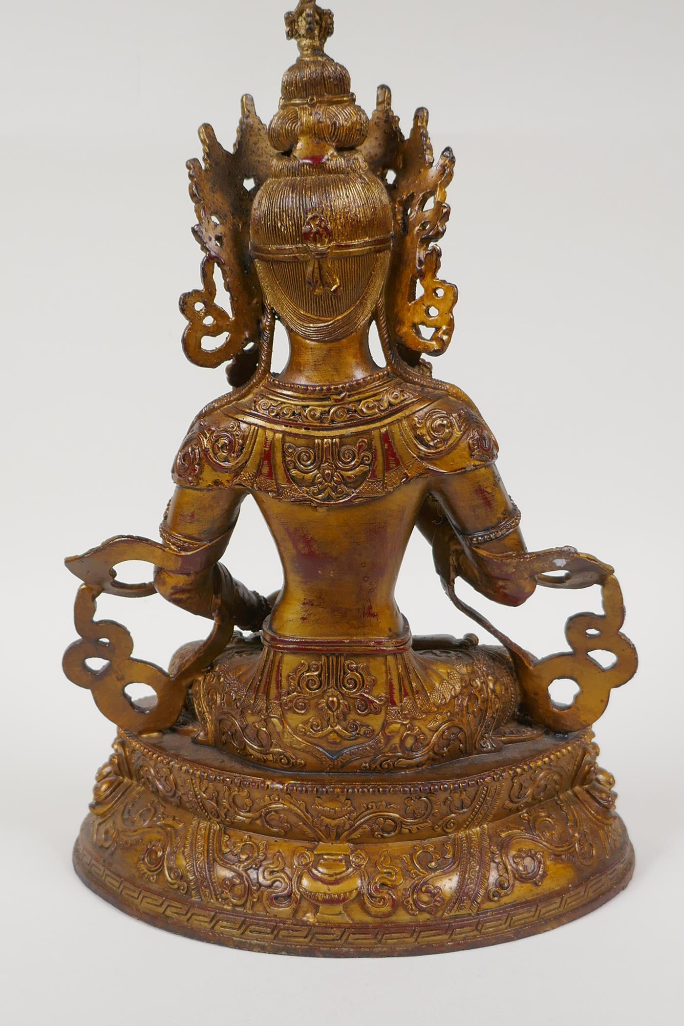 A Sino Tibetan gilt bronze of Buddha carrying two vajra, 12" high - Image 3 of 4