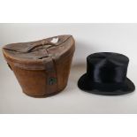 A silk top hat by Henry Heath Ltd in a leather fitted hat box