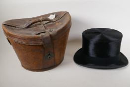 A silk top hat by Henry Heath Ltd in a leather fitted hat box