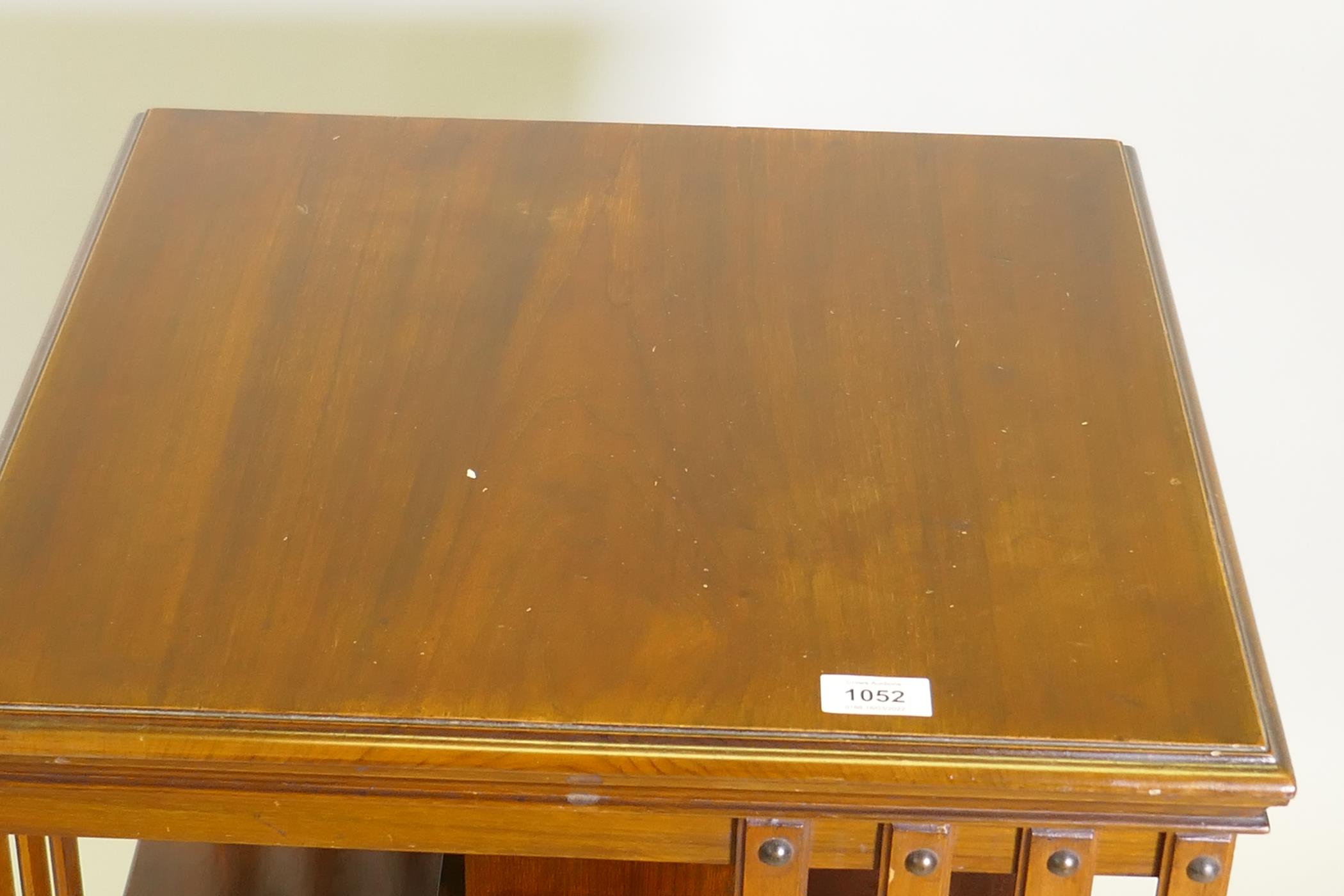 A Victorian walnut revolving bookcase, raised on a cast iron base, 20" x 20" x 34" - Image 2 of 3